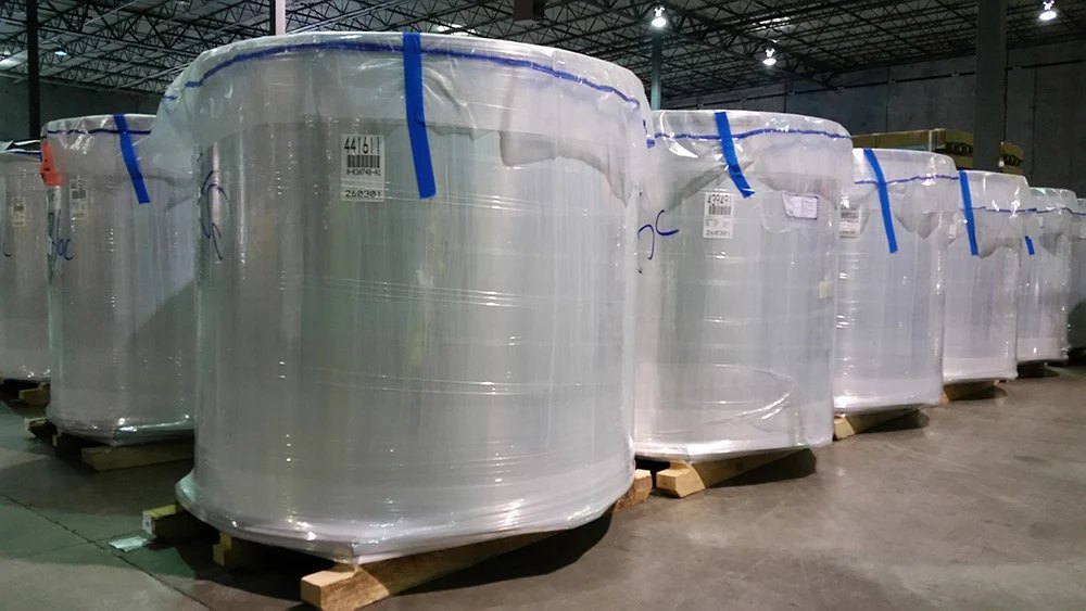 Imported aluminum coils wrapped and stored in rows at the Hanahan warehouse